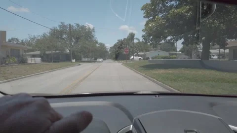 Car Front Window View Of Road in Florida City making a Right Turn. Stock Footage 240600230