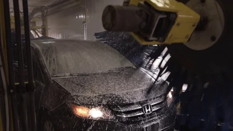Car Gets Cleaned Angled View Washer At Car Wash Stock Footage 87889600