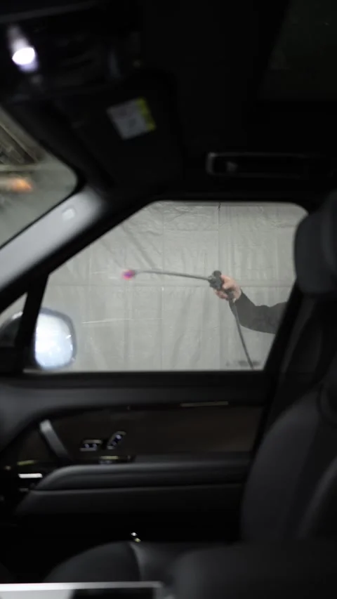 Car gets covered in cleaning foam during professional exterior washing Stock Footage 346545062