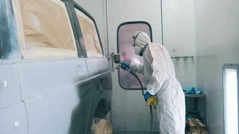 Car is getting coloured by the garage worker Stock Footage 114489327