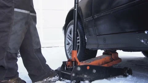 Car getting dropped down by jack Stock Footage 170697252