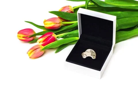 Car as gift for woman, concept. Miniature car in open gift box, tulips Stock Photos