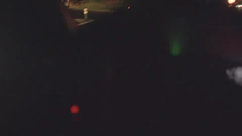 A car glides down a highway at night, lights piercing the darkness Stock Footage 317339817