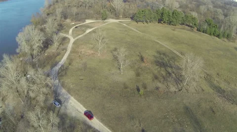 Car goes across e field near the river .Aerial Stockbeeldmateriaal 36519928