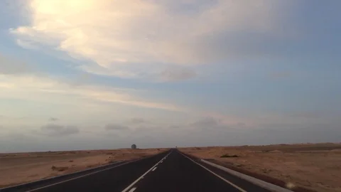 The car goes on an African road. To meet this car goes another car.  Stock Footage