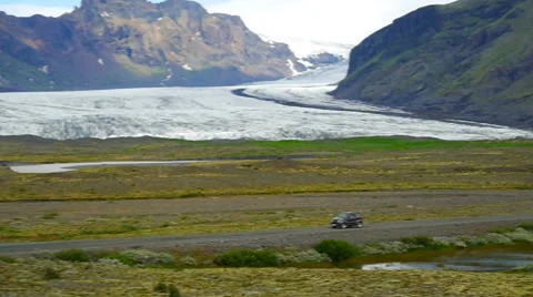 The car goes on the background of the glacier Stock Footage 59974823