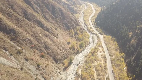 The car goes between the hills to the top of the mountain. Almaty, Kazakhstan Stock Footage 99461574