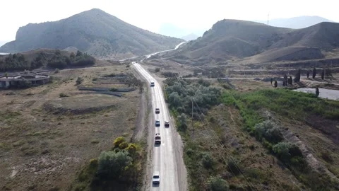 The car goes between the mountains Stock Footage 231034993