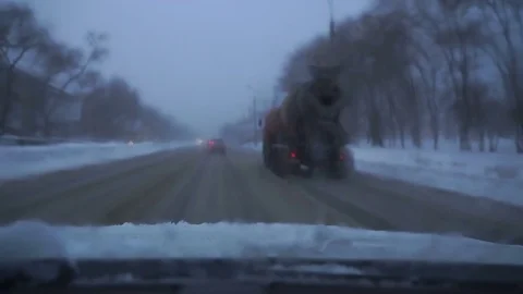 Car goes down the road in winter snow Stock Footage 72165826