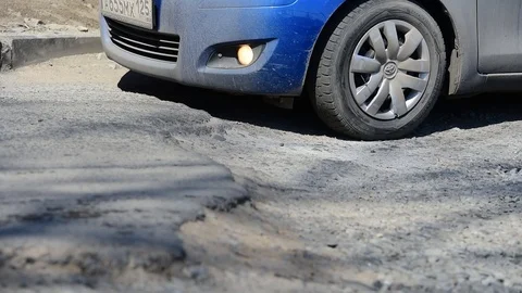 The car goes  a pothole. Wheels close up. Stock Footage 88071822