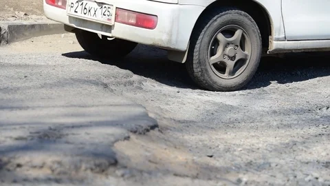 The car goes  a pothole. Wheels close up. Stock Footage 88117867
