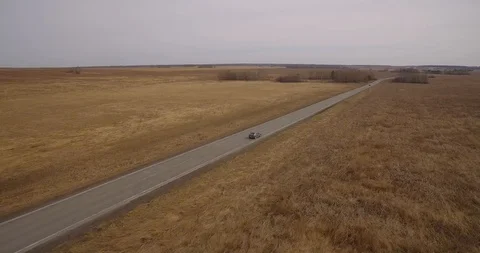 The car goes on the road in the field. Stock Footage 89606684