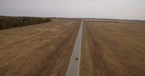 The car goes on the road in the field. Stock Footage 89607529