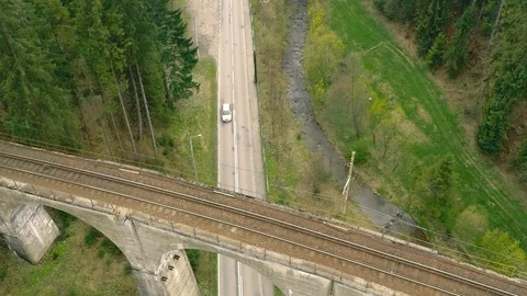 The car goes through the forest, under the railway bridge Stock Footage 92832373