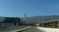 Car going down motorway, big city against mountains in front, communication HD Footage