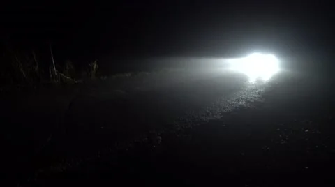 Car going on empty night road in heavy fog. 4K Stock-Footage 59737736