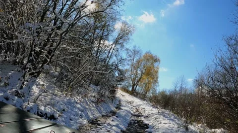 The car is hardly driving through snowy mountainous terrain, in sunny weather Stock Footage 171957653