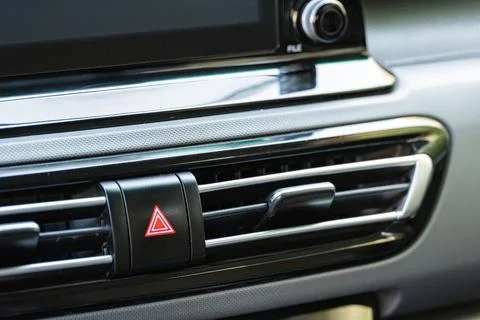 Car hazard warning lights button and air conditioning vent close up Fotos Stock