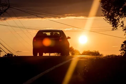 Car heading to sunset Stock Photos
