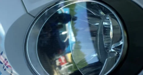 Car Headlight With Chrome Reflector and Clear Lens in Close Up Stock Footage 340261398