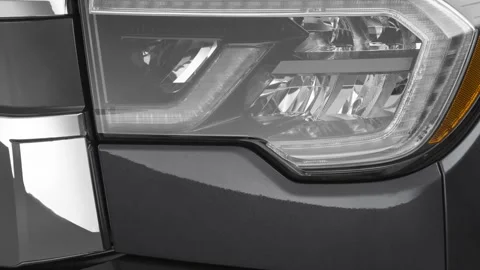 Car headlight close up Bellanova White Pearl 2020 Toyota Sequoia Limited SUV Stock Footage 160094590