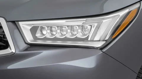 Car headlight close up Celestial Silver Metallic 2017 Acura MDX Stock Footage 159935015