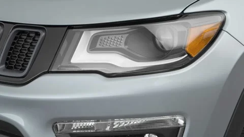 Car headlight close up Daytona Gray Pearl Effect 2017 Jeep Compass Trailhawk Stock Footage 159947925