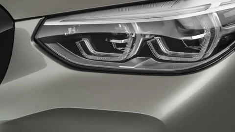 Car headlight close up Ice Silver Metallic 2020 BMW X3 M Competition Stock Footage 160084599