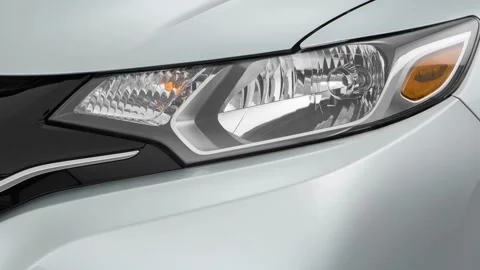 Car headlight close up Luminous Sand Metallic 2016 Honda Fit EX Stock Footage 159857654