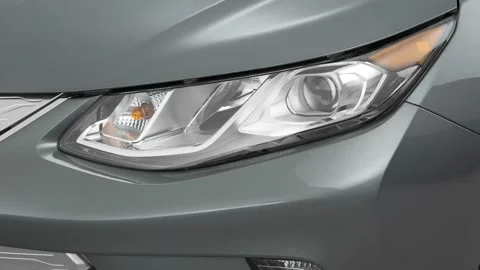 Car headlight close up Machine Gray Metallic 2016 Chevrolet Volt LT Stock Footage 159853027