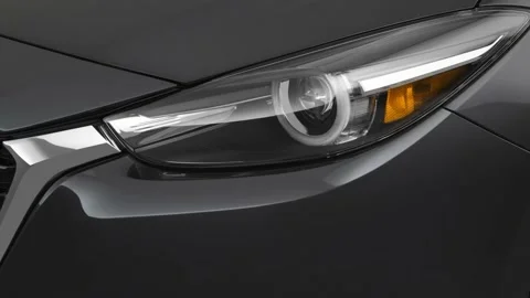 Car headlight close up Machine Gray Metallic 2018 Mazda MAZDA3 Grand Touring Stock Footage 159966354