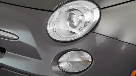Car headlight close up Magnetic Gray Metallic 2017 Fiat 500 Pop Video stock 159908190
