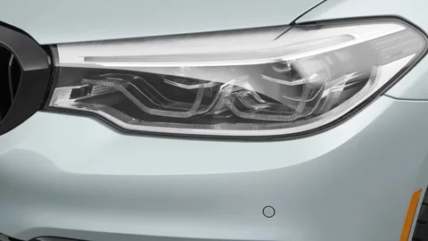 Car headlight close up Magnetic Gray Metallic 2017 BMW 5-series 540i Stock Footage 159939248