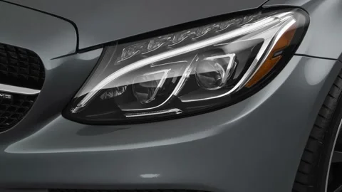 Car headlight close up Platinum Graphite 2018 Mercedes-Benz C-Class AMG C43 Stock Footage 159976079