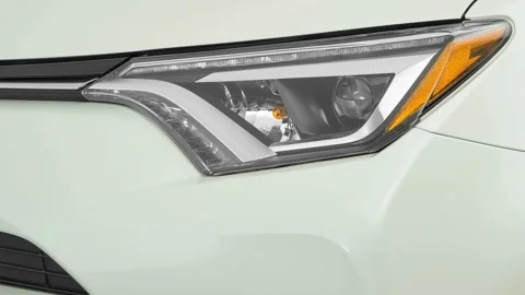 Car headlight close up Platinum Gray Metallic 2016 Toyota RAV4 Limited Stock Footage 159881658