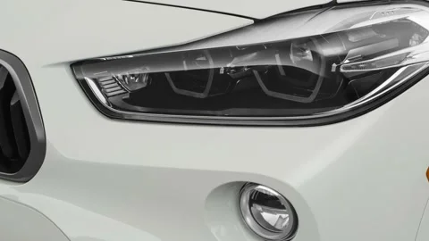 Car headlight close up Platinum Gray Metallic 2019 BMW X2 M35i Stock Footage 160064352