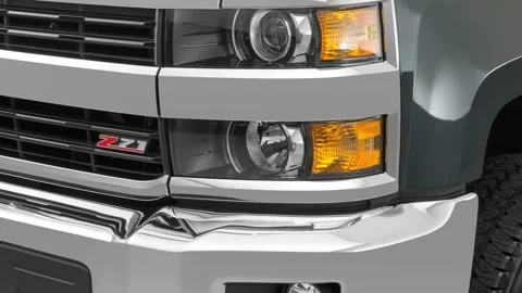 Car headlight close up Predawn Gray Mica 2017 Chevrolet Silverado 2500HD LT Stock Footage 159926903