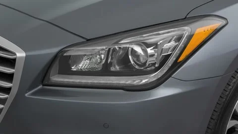 Car headlight close up Ruby Red Tinted Clearcoat 2016 Hyundai Genesis 3.8 Stock Footage 159868509