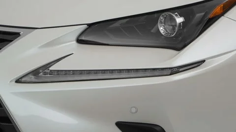 Car headlight close up Ruby Red Tinted Clearcoat 2018 Lexus NX Hybrid NX 300h Stock Footage 159987693