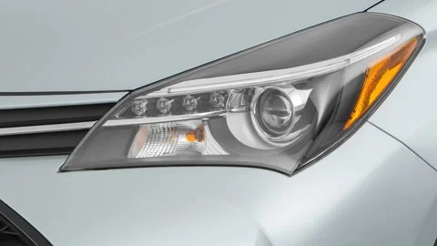 Car headlight close up Silver Ice Metallic 2016 Toyota Yaris SE Stock Footage 159875960