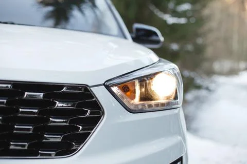 Car headlight close up in the winter forest Stock Photos