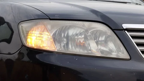 Car headlight flashing close up Stock Footage 129411033