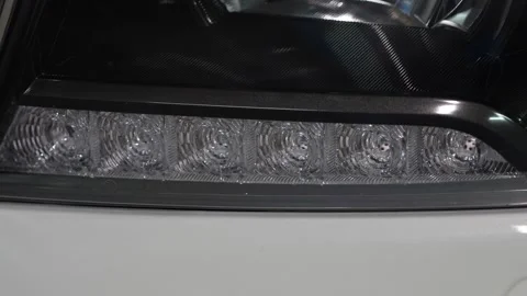 Car headlight integrated LED daytime running lights (DRL) strip. Stock Footage 344597982