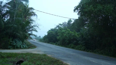 A Car With Headlight On Passing By A Cornering Road In Quiet Rural Area Stock Footage 34731142
