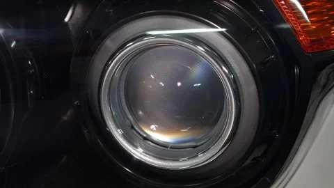 Car headlight projector lens module with a black shroud. Stock Footage 344598074
