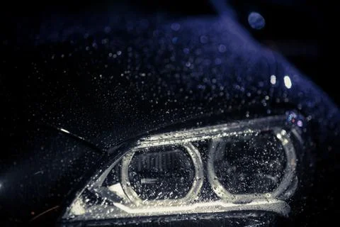 Car headlight with rain drops Stock Photos