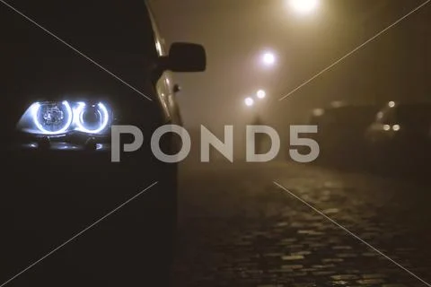 The car headlight with a walking man on the background of a fog Stock Photos