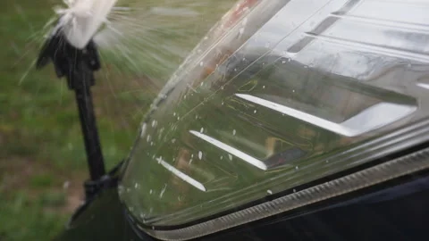 Car headlight washers spray liquid onto the headlights. Stock Footage 129844566