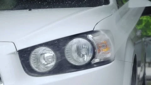 Car headlight washers spray liquid onto the headlights Stock Footage 131171106