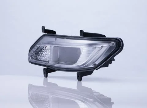 A car headlight on white background with reflection Stock Photos